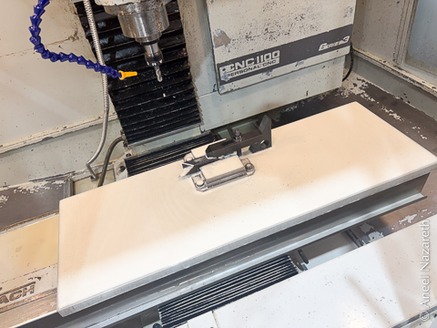 A CNC mill where the entire table is covered with coolant froth